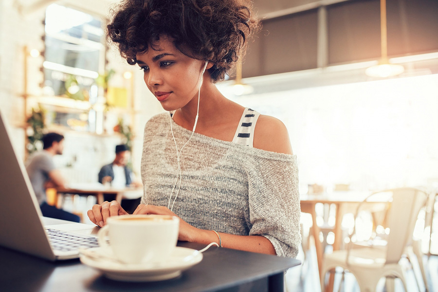 Woman using free WiFi in restaurant